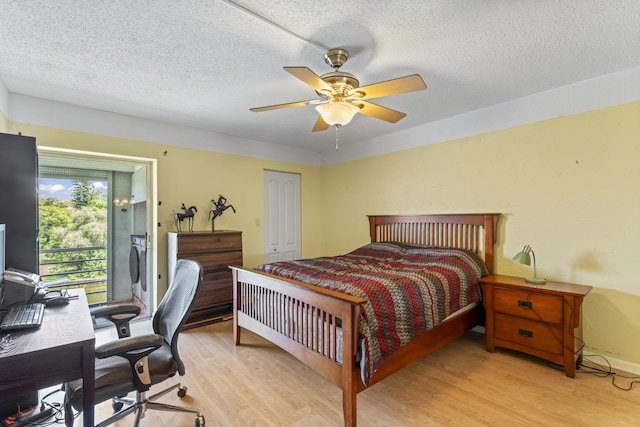bedroom with light wood-style floors, access to exterior, an office area, a textured ceiling, and ceiling fan