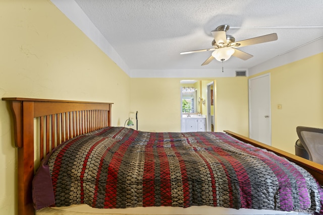 bedroom featuring a textured ceiling, connected bathroom, and ceiling fan