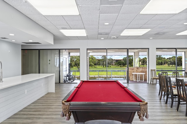 recreation room with wood finished floors, billiards table, and a drop ceiling