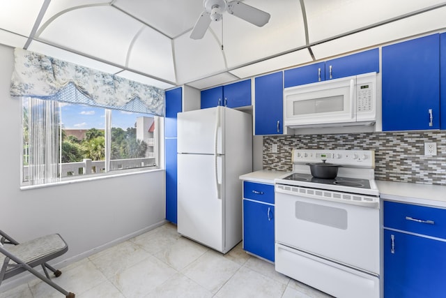kitchen with white appliances, blue cabinets, decorative backsplash, and light countertops
