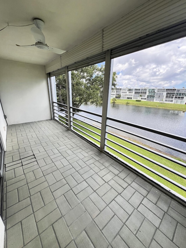 3037 Cambridge B, Deerfield Beach, FL 33442 - unfurnished sunroom with a ceiling fan and a water view