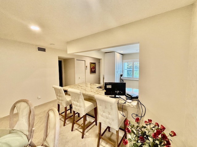 21728 Arriba Real A 34-A, Boca Raton, FL 33433 - kitchen featuring a kitchen breakfast bar, light stone counters, light colored carpet, and recessed lighting