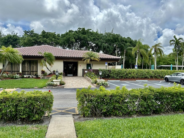 21728 Arriba Real A 34-A, Boca Raton, FL 33433 - view of front of house with a tile roof, uncovered parking, and stucco siding