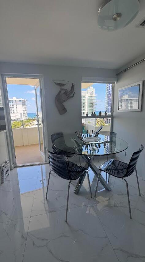 215 N Birch Rd Unit 8C, Fort Lauderdale, FL 33304 - dining space featuring marble finish floors