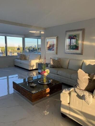215 N Birch Rd Unit 8C, Fort Lauderdale, FL 33304 - living area featuring healthy amount of natural light and marble tiled flooring