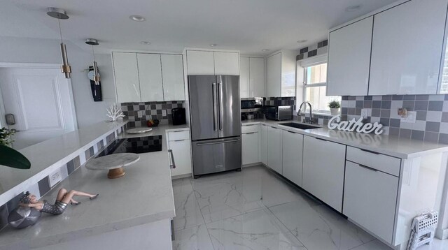 215 N Birch Rd Unit 8C, Fort Lauderdale, FL 33304 - kitchen with stainless steel appliances, a sink, tasteful backsplash, light marble finish floors, and white cabinets