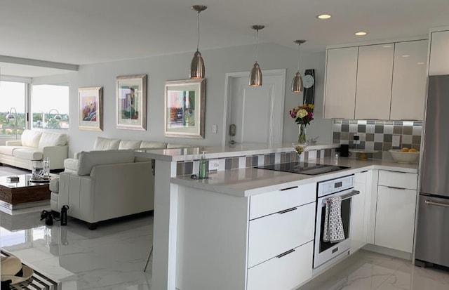 215 N Birch Rd Unit 8C, Fort Lauderdale, FL 33304 - kitchen with oven, freestanding refrigerator, black electric stovetop, light marble finish floors, and a peninsula