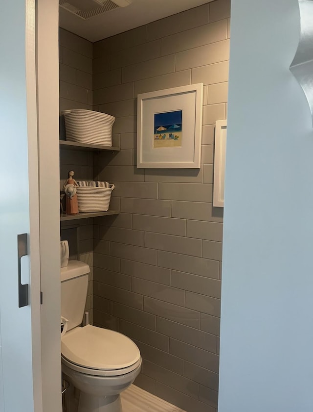 215 N Birch Rd Unit 8C, Fort Lauderdale, FL 33304 - bathroom featuring toilet and tile walls