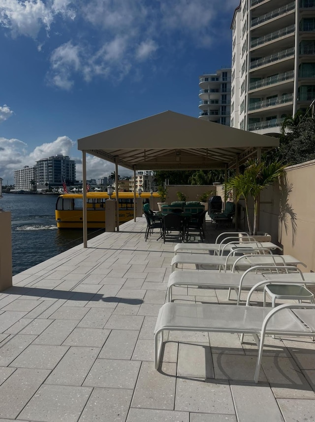 215 N Birch Rd Unit 8C, Fort Lauderdale, FL 33304 - view of patio / terrace featuring a water view, fence, and outdoor dining area