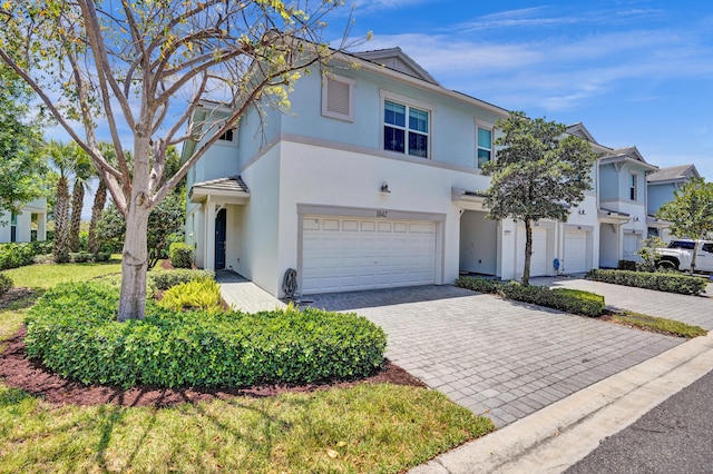 1842 Sandpiper Pointe Pl, Deerfield Beach, FL 33442 - view of front facade with stucco siding, a garage, and decorative driveway