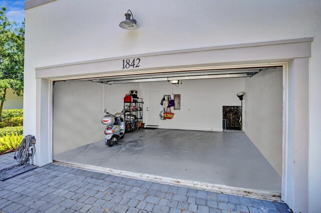 1842 Sandpiper Pointe Pl, Deerfield Beach, FL 33442 - garage with a garage door opener, electric panel, and decorative driveway