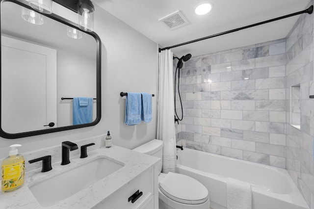 bathroom featuring toilet, shower / bath combo, and vanity