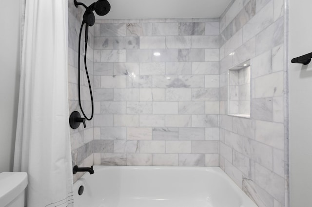 bathroom featuring toilet and shower / tub combo with curtain