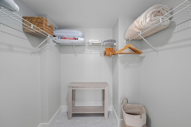 spacious closet with tile patterned floors