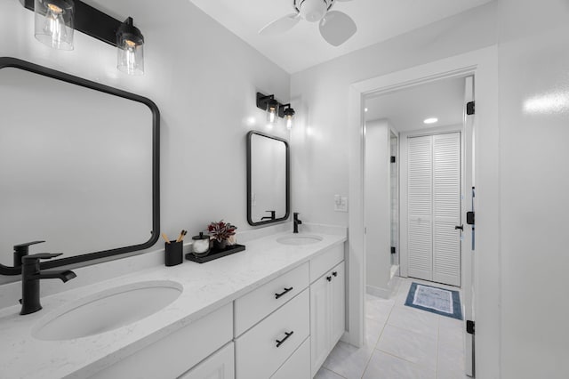 bathroom with double vanity, a ceiling fan, and tile patterned flooring