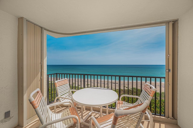 balcony featuring view of water and beach