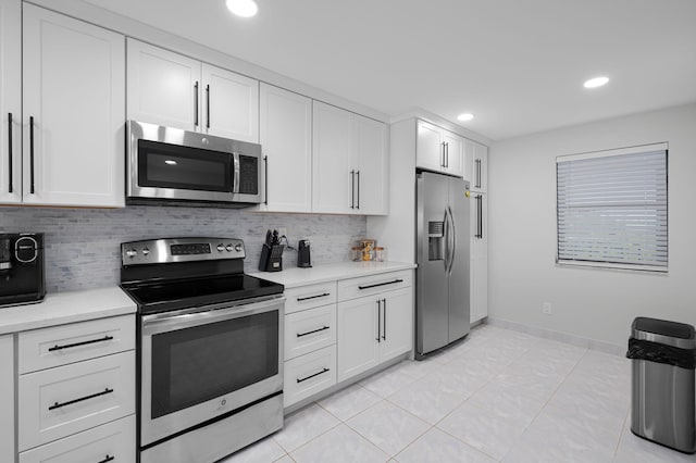 kitchen featuring appliances with stainless steel finishes, tasteful backsplash, light countertops, white cabinetry, and recessed lighting