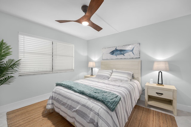 bedroom featuring baseboards and ceiling fan