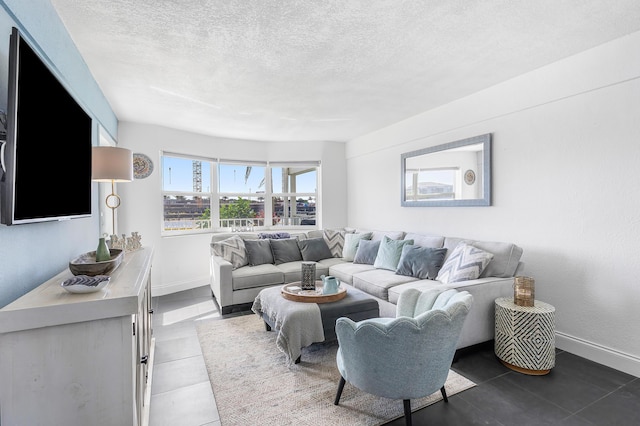 1536 SE 15th Ct Unit 107, Deerfield Beach, FL 33441 - living room featuring a textured ceiling, baseboards, and tile patterned flooring