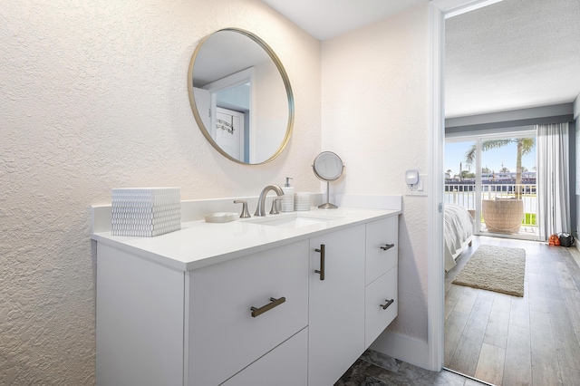 1536 SE 15th Ct Unit 107, Deerfield Beach, FL 33441 - ensuite bathroom featuring a textured wall and vanity