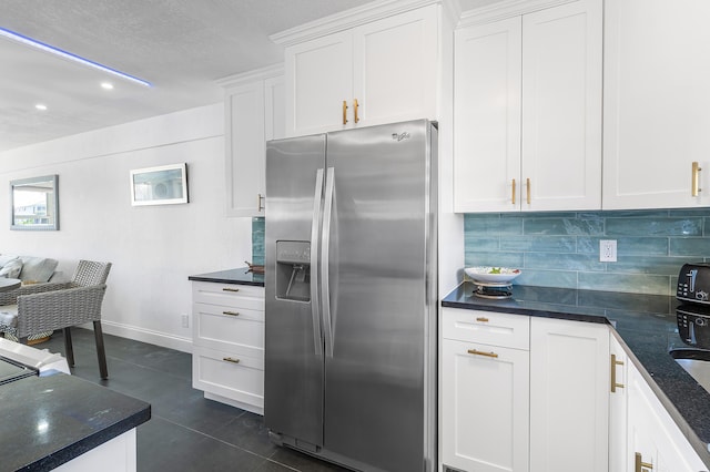 1536 SE 15th Ct Unit 107, Deerfield Beach, FL 33441 - kitchen with stainless steel fridge with ice dispenser, decorative backsplash, white cabinets, dark tile patterned floors, and recessed lighting