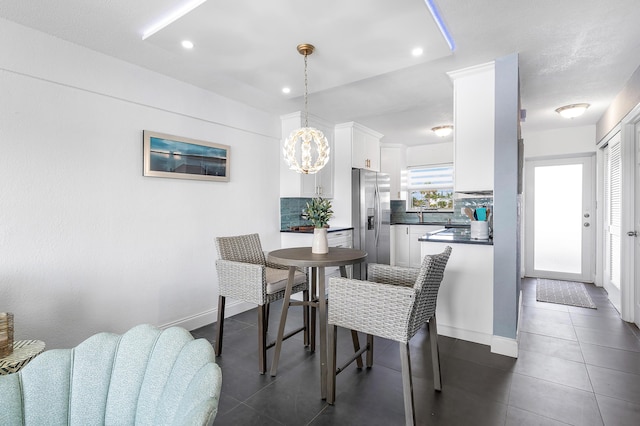 1536 SE 15th Ct Unit 107, Deerfield Beach, FL 33441 - dining area featuring dark tile patterned flooring, a chandelier, recessed lighting, and baseboards