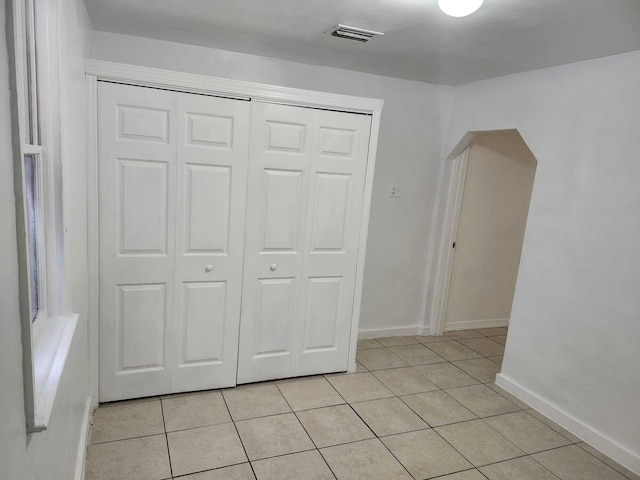 119 S Price St S, Lake Worth, FL 33461 - unfurnished bedroom with light tile patterned floors, a closet, and baseboards