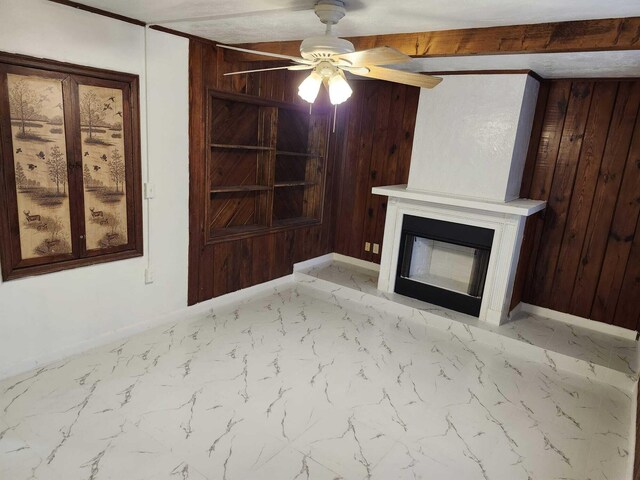 119 S Price St S, Lake Worth, FL 33461 - unfurnished living room with wood walls, ceiling fan, a glass covered fireplace, light marble finish flooring, and baseboards