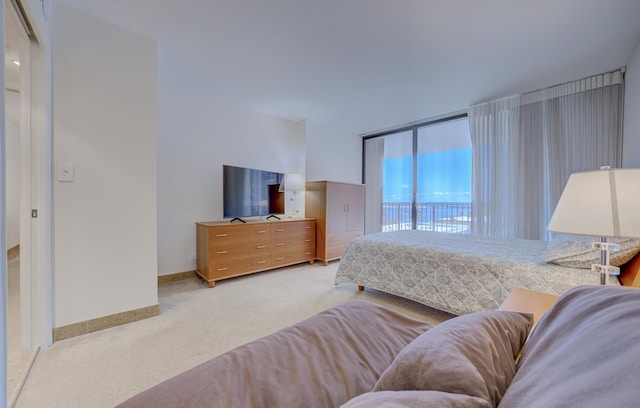 1865 Brickell Ave Unit A611, Miami, FL 33129 - bedroom with access to exterior, light carpet, and baseboards