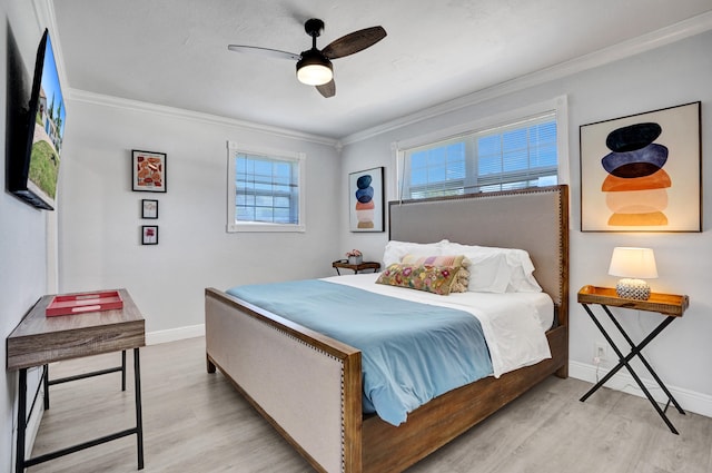 bedroom with crown molding, light wood finished floors, baseboards, and ceiling fan