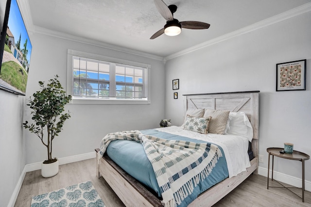 bedroom featuring ornamental molding, wood finished floors, baseboards, and ceiling fan