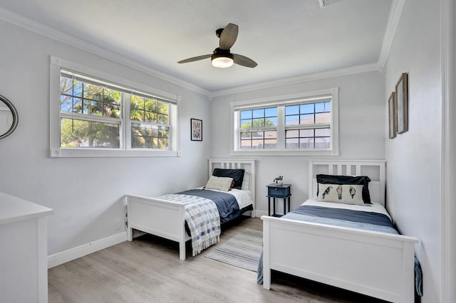 bedroom with light wood-style flooring, crown molding, baseboards, and a ceiling fan