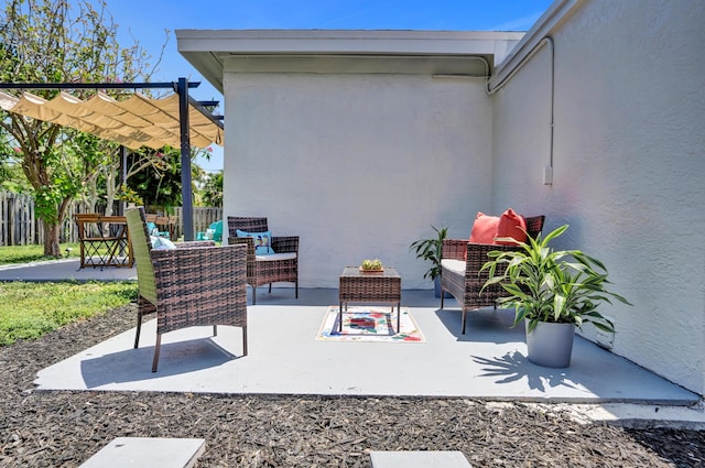 view of patio with a pergola and fence