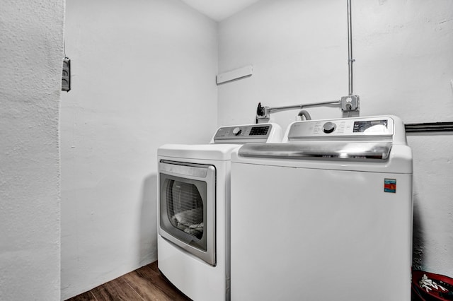 washroom featuring washing machine and clothes dryer and wood finished floors