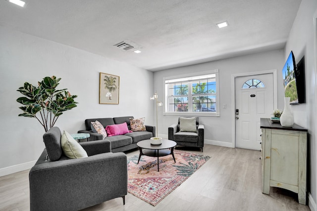 living area with light wood-style floors and baseboards