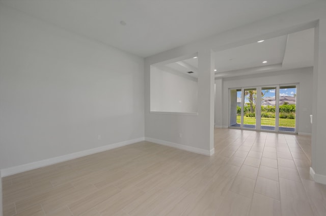 unfurnished room with baseboards and recessed lighting