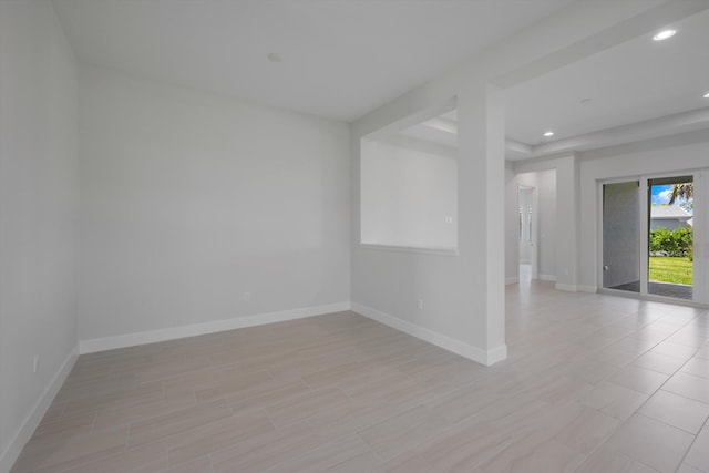 empty room featuring recessed lighting and baseboards