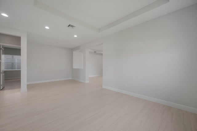 empty room with recessed lighting, baseboards, and light wood finished floors