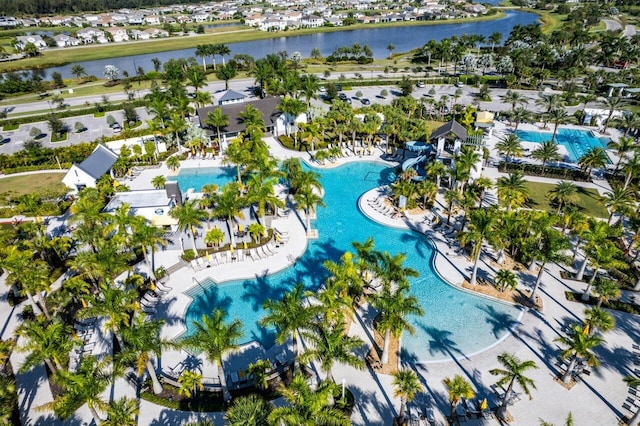 bird's eye view of a pool area and a large body of water
