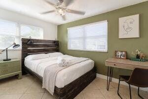 103 SE 5th Ave, Boynton Beach, FL 33435 - bedroom featuring light tile patterned floors, a ceiling fan, and baseboards
