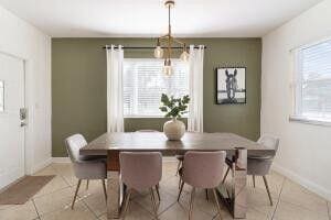 103 SE 5th Ave, Boynton Beach, FL 33435 - dining room featuring light tile patterned flooring, a chandelier, and baseboards