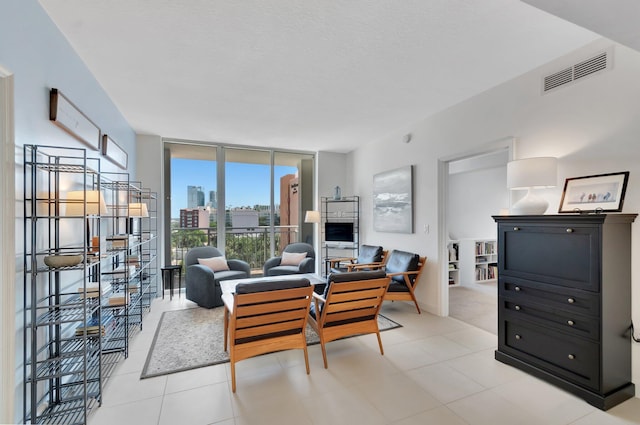 480 Hibiscus St Unit 709, West Palm Beach, FL 33401 - living area featuring floor to ceiling windows and light tile patterned floors