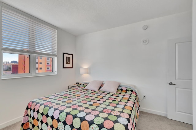 480 Hibiscus St Unit 709, West Palm Beach, FL 33401 - bedroom with carpet floors, baseboards, and a textured ceiling