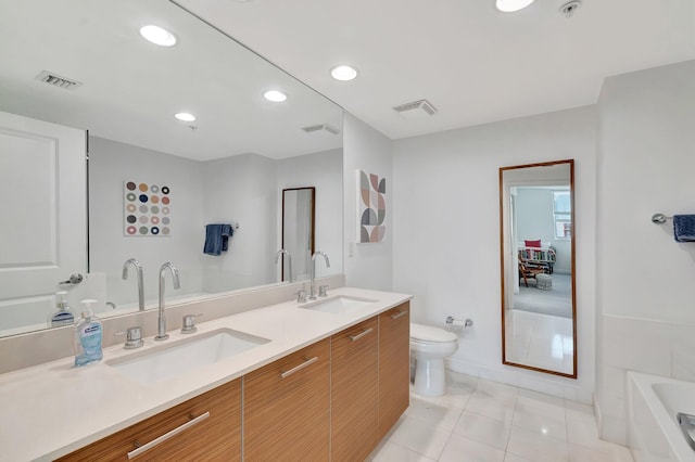 480 Hibiscus St Unit 709, West Palm Beach, FL 33401 - bathroom featuring tile patterned floors, recessed lighting, toilet, double vanity, and baseboards