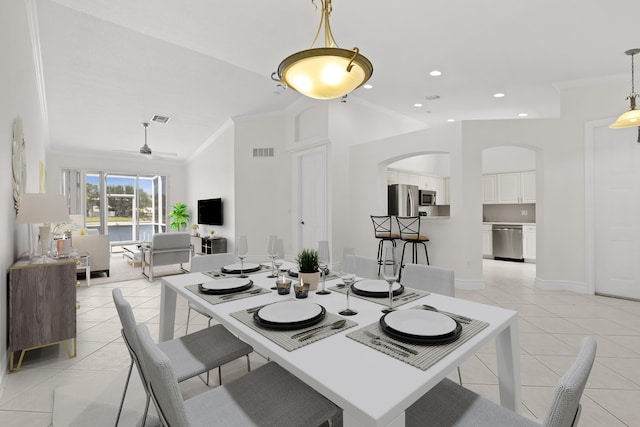 8623 Mangrove Cay, West Palm Beach, FL 33411 - dining space with ornamental molding, arched walkways, light tile patterned floors, ceiling fan, and baseboards