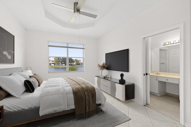 8623 Mangrove Cay, West Palm Beach, FL 33411 - bedroom with light tile patterned floors, connected bathroom, a tray ceiling, and ceiling fan