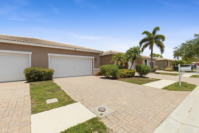 8623 Mangrove Cay, West Palm Beach, FL 33411 - view of front facade with decorative driveway, stucco siding, and a tile roof