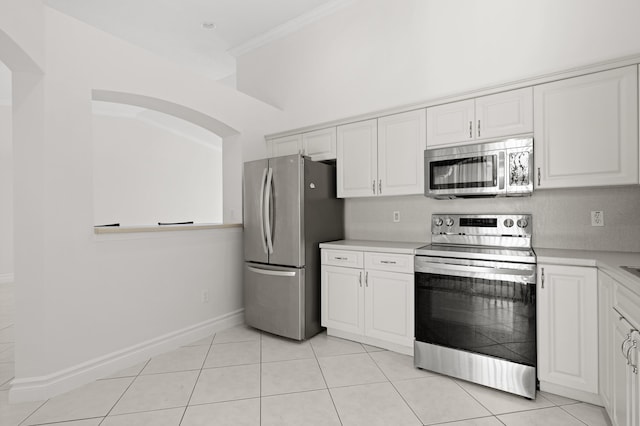 8623 Mangrove Cay, West Palm Beach, FL 33411 - kitchen featuring stainless steel appliances, light countertops, white cabinets, light tile patterned floors, and crown molding
