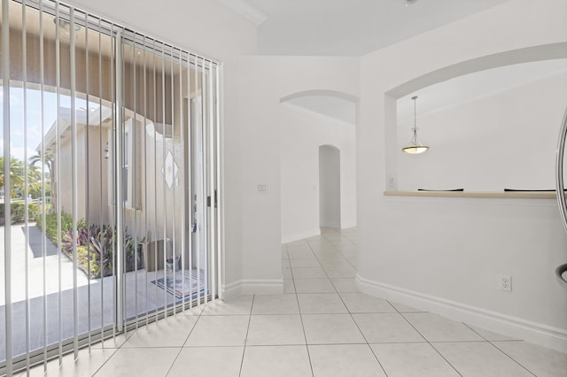 8623 Mangrove Cay, West Palm Beach, FL 33411 - hall featuring arched walkways, crown molding, tile patterned floors, and baseboards