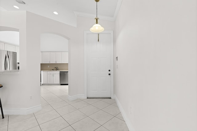 8623 Mangrove Cay, West Palm Beach, FL 33411 - entrance foyer featuring arched walkways, light tile patterned flooring, ornamental molding, and baseboards